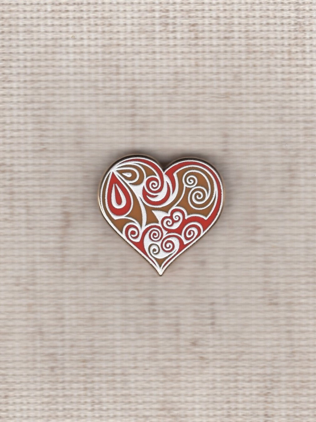 red swirl heart needle minder